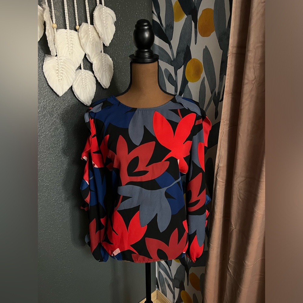 Cute work or party top! No wrinkle/perfect for travel. Ruffle detail on sleeve.